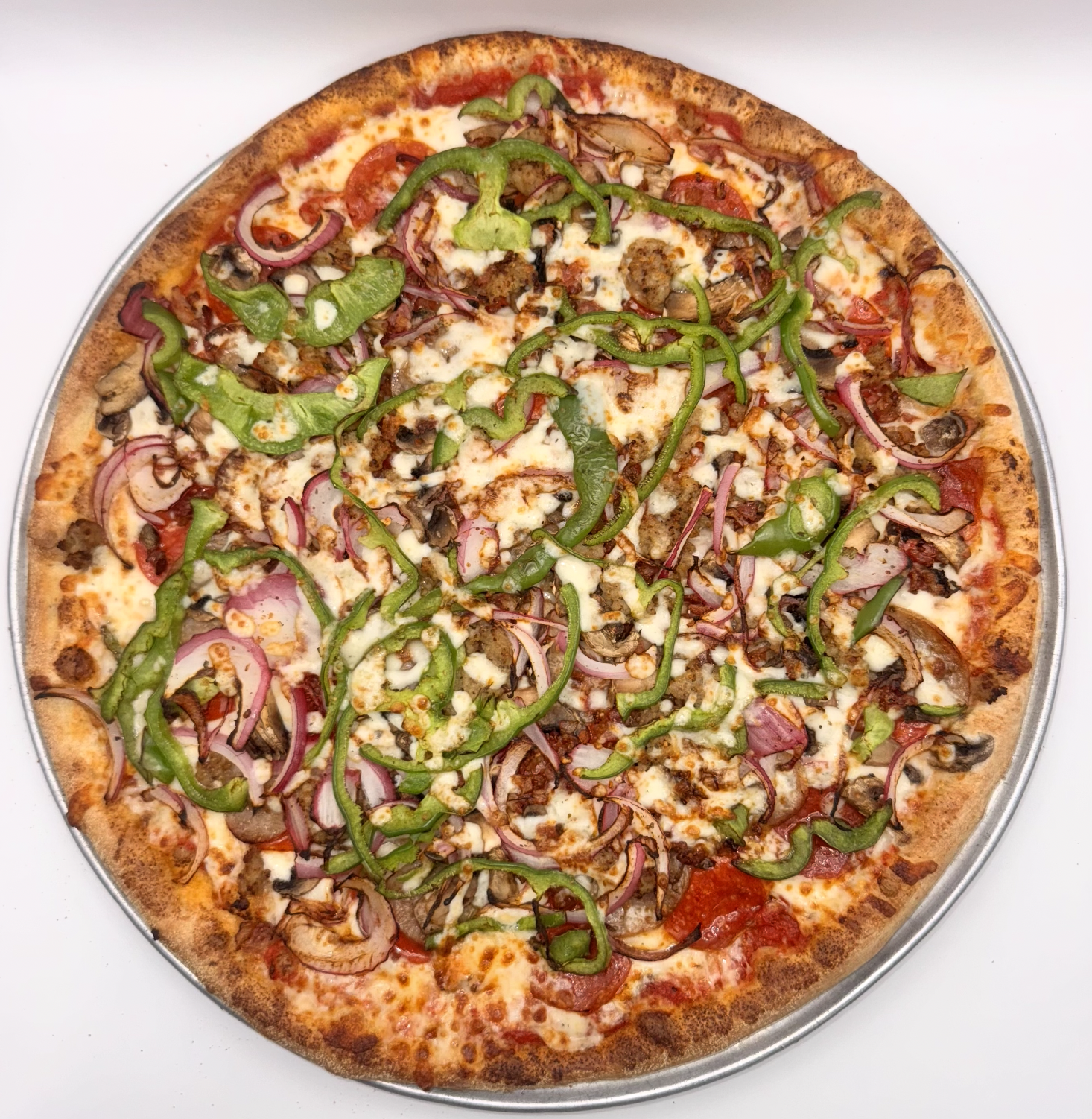 Annie's specialty pizza topped with meat, onions, and fresh herbs